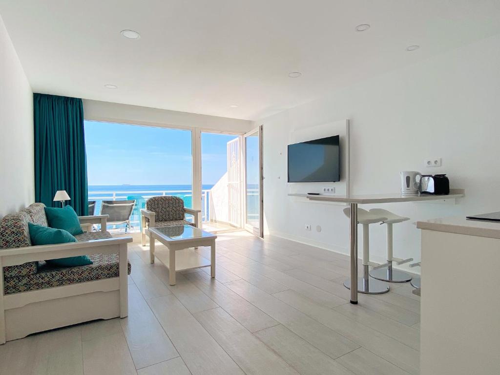 a living room with a view of the ocean at Acapulco Ocean View in San Agustin