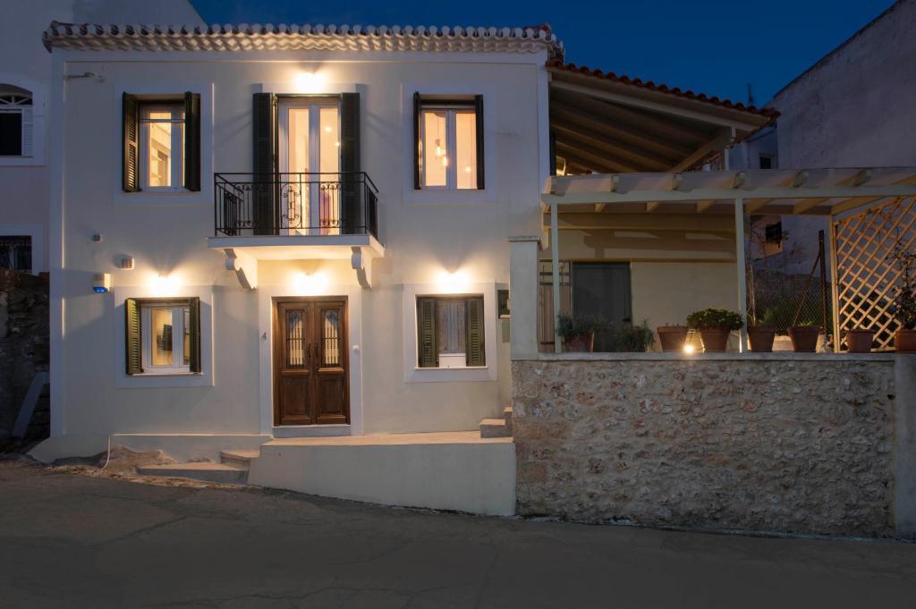 a white house with lights on the front of it at Nestor's studio house in Pylos