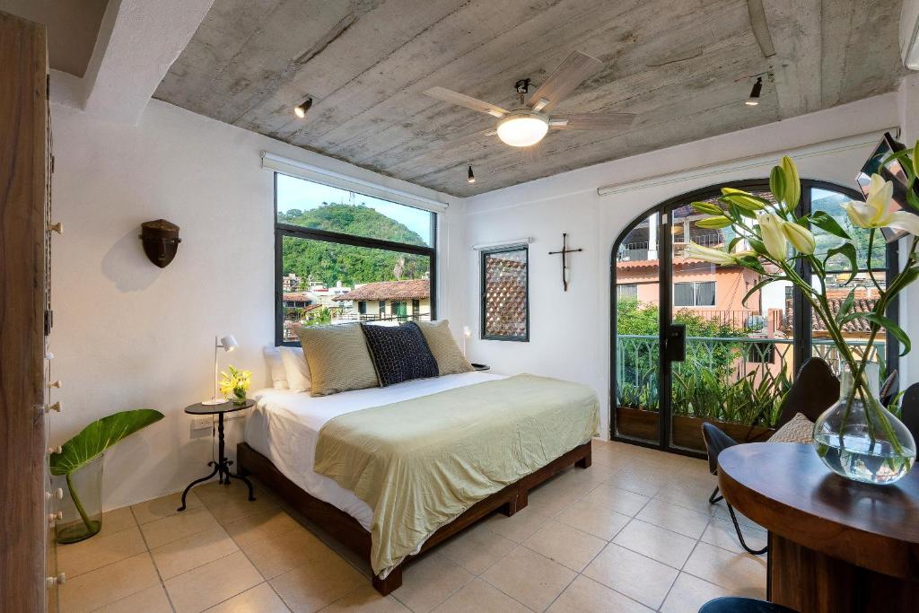 a bedroom with a bed and a window at Casa Lucas in Puerto Vallarta