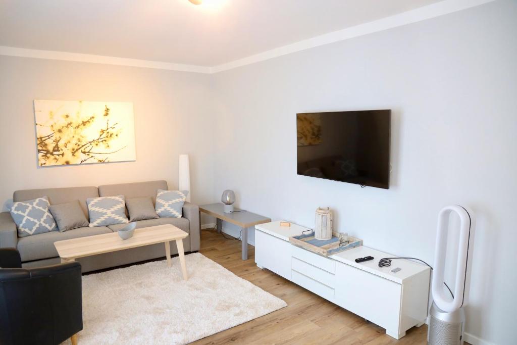 sala de estar con sofá y TV en Haus Renate en Timmendorfer Strand