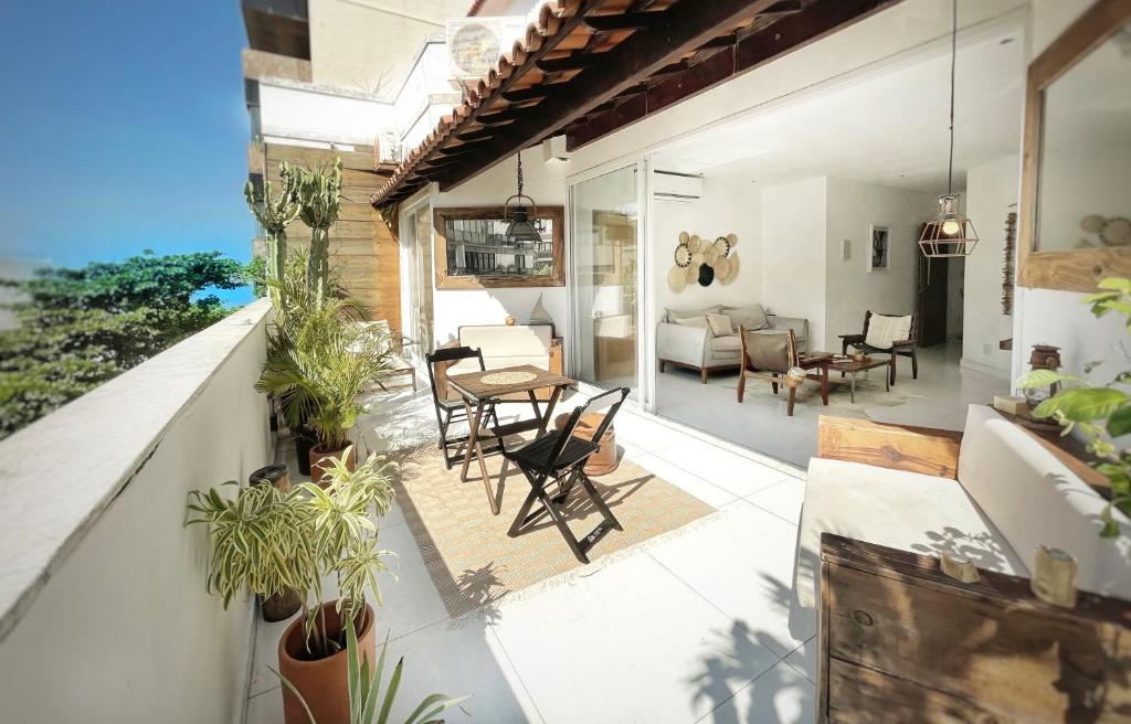 an indoor patio with chairs and a living room at Ipanema Penthouse in Rio de Janeiro