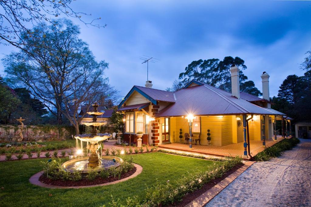 a house with a fountain in the yard at Mountain Whispers Varenna Luxury in Leura