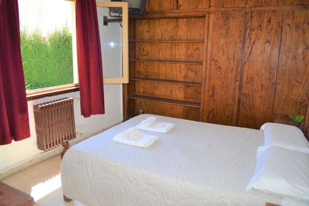 Tempat tidur dalam kamar di Hotel Taormina by CPH