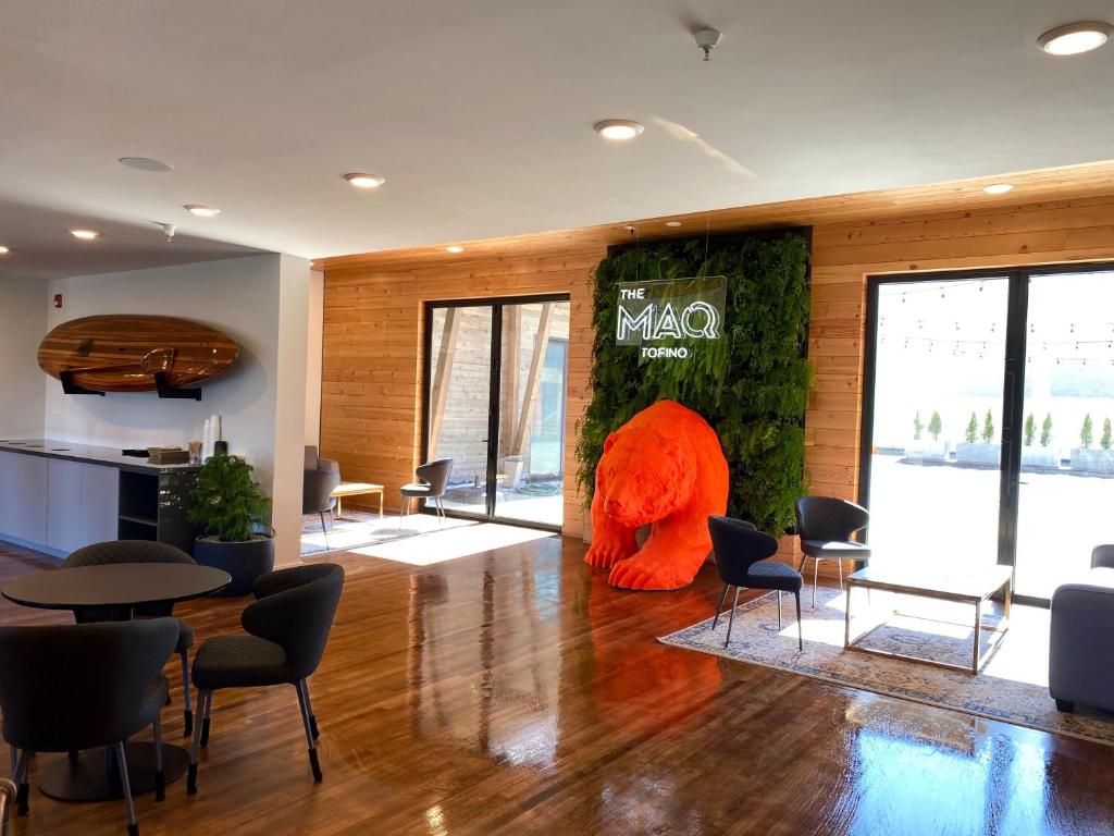 an office lobby with an orange sculpture on the wall at The Maq Hotel in Tofino