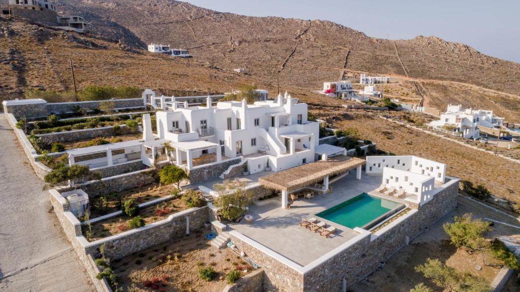 an aerial view of a white house with a swimming pool at Bohemian Blue Villa - 7 BDRM - beach in 200m - MG Villas in Panormos Mykonos