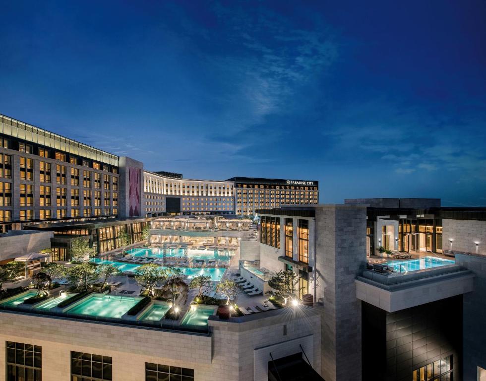 a view of a hotel with a pool at night at Paradise City in Incheon