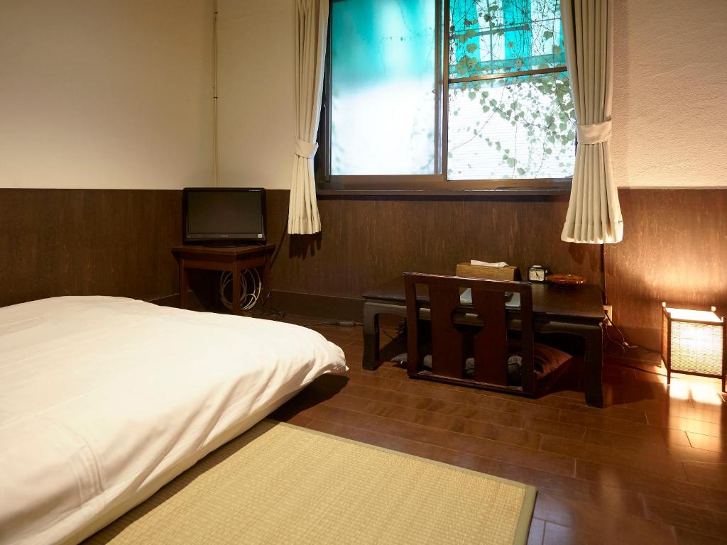 Postel nebo postele na pokoji v ubytování Takeyaso Ryokan
