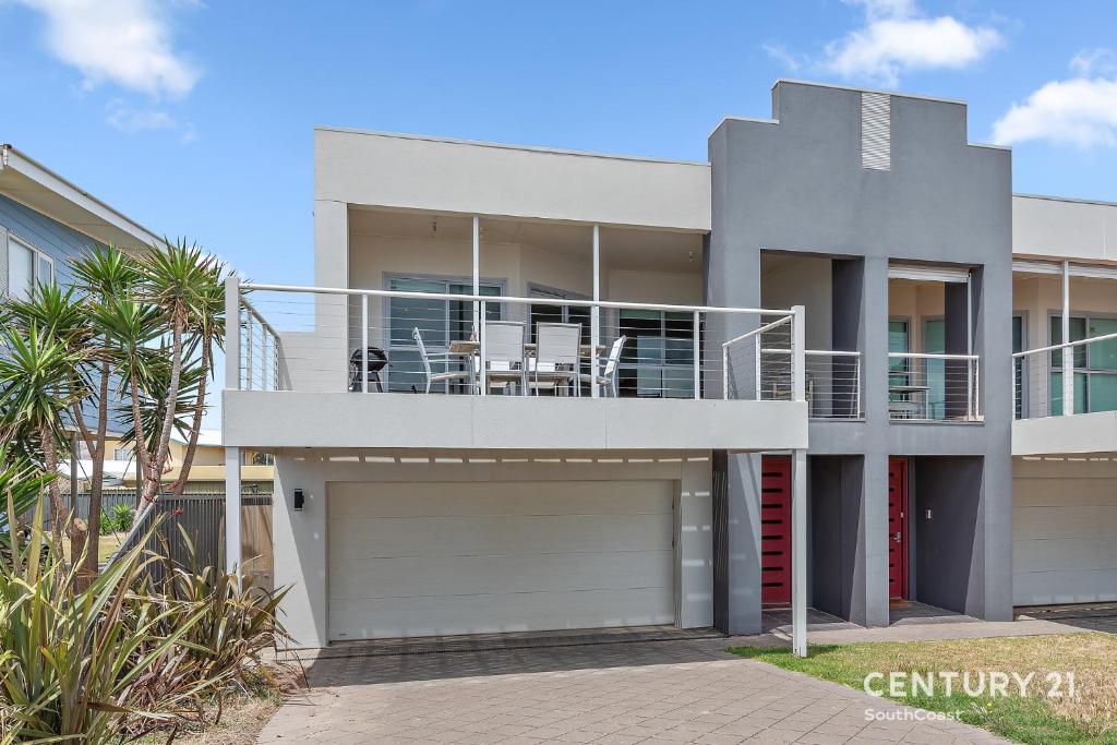 a house with a balcony and a garage at Percival Point - Port Willunga - C21 SouthCoast Holidays in Port Willunga