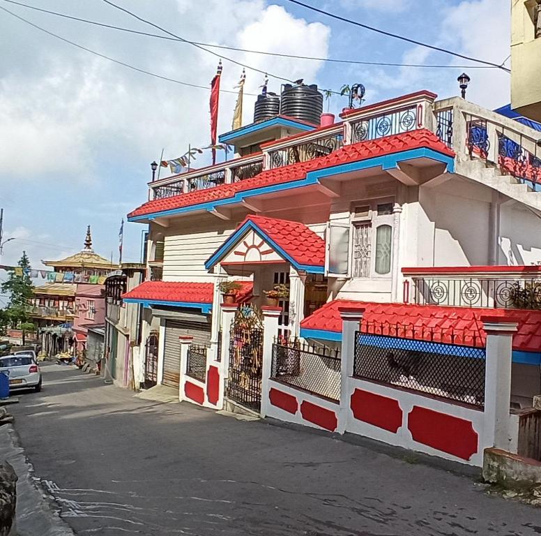 a building with red roofs on a street at B&B Homestay in Darjeeling