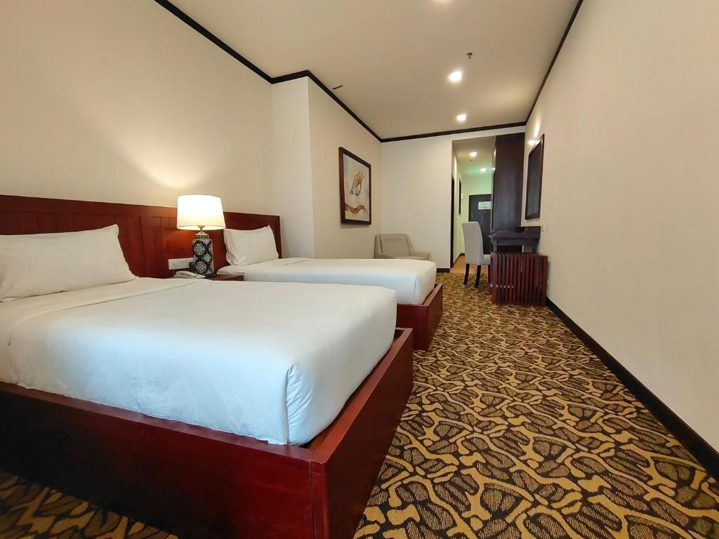 Postel nebo postele na pokoji v ubytování Riviera Suites Melaka