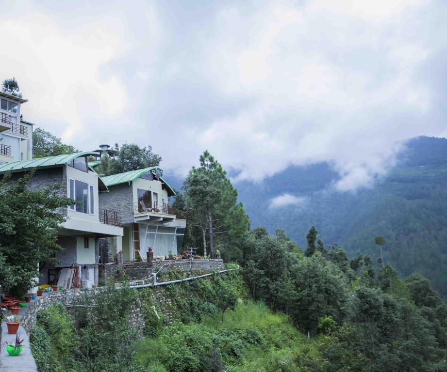 a house on the side of a hill with trees at Seclude Ramgarh Cliff's edge in Rāmgarh