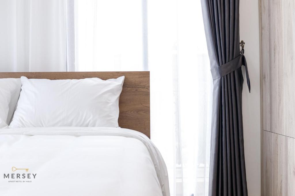 Postel nebo postele na pokoji v ubytování Mersey Central Hanoi Apart'Hotel