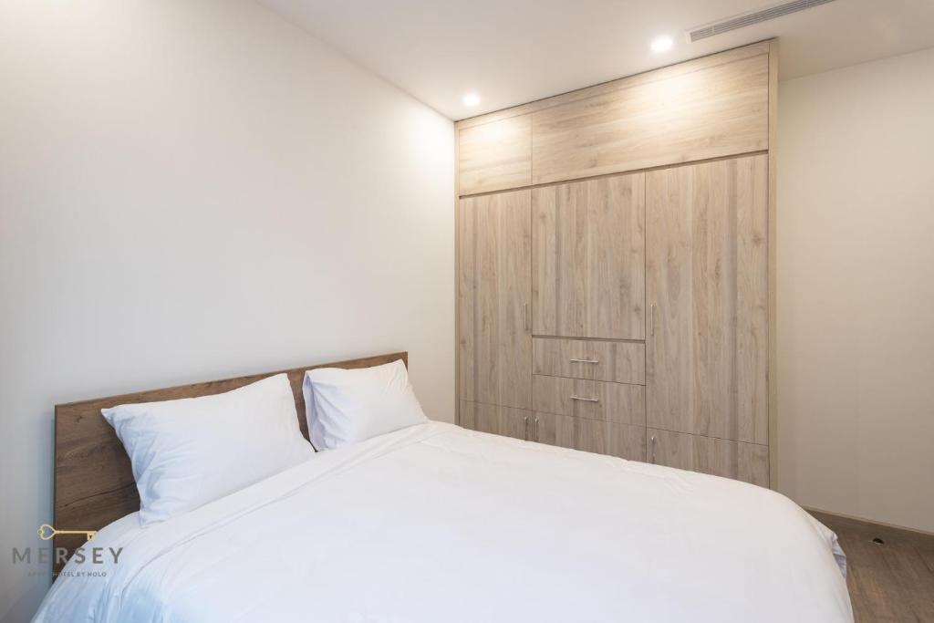 Postel nebo postele na pokoji v ubytování Mersey Central Hanoi Apart'Hotel