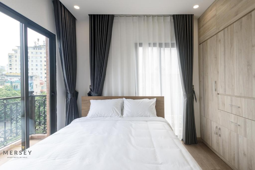 Postel nebo postele na pokoji v ubytování Mersey Central Hanoi Apart'Hotel