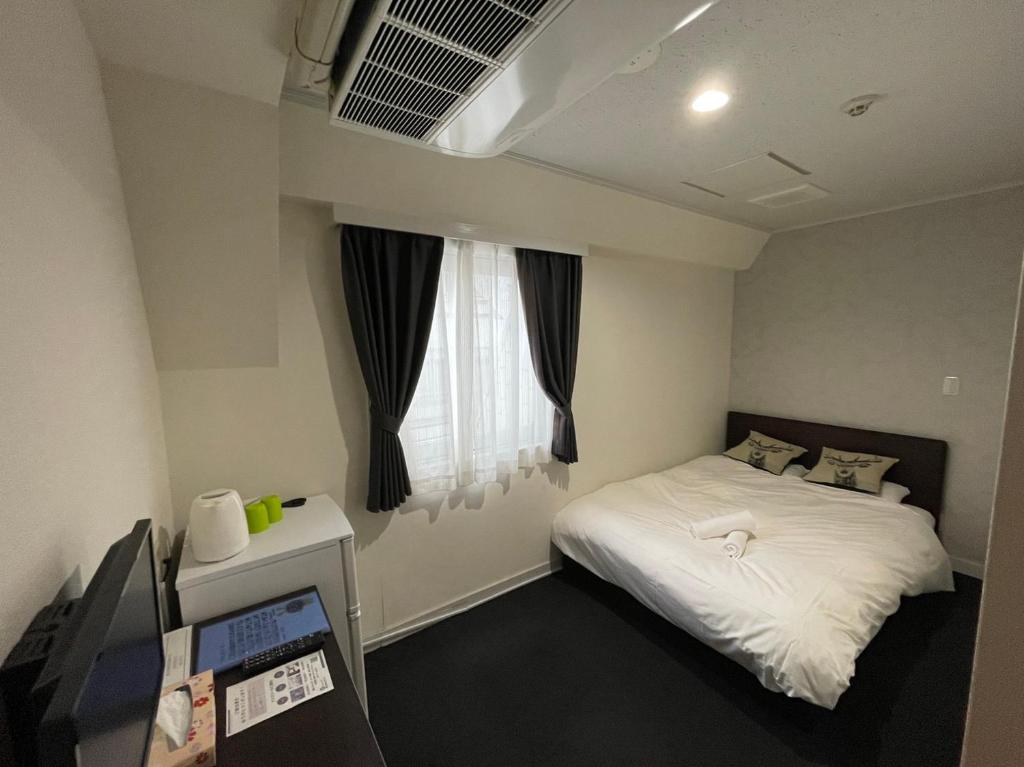 Кровать или кровати в номере Exsasion Sugamo