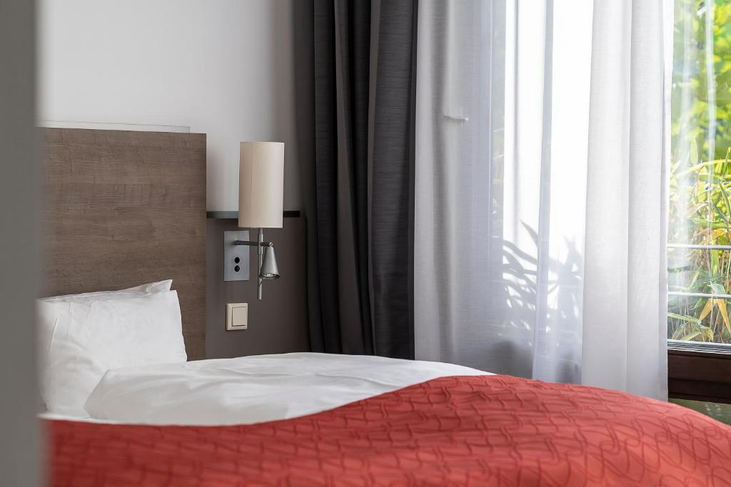 Postel nebo postele na pokoji v ubytování Art & Business Hotel