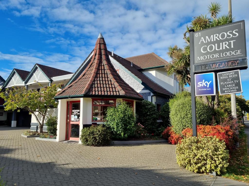 a inn with a sign in front of a building at Amross Court in Christchurch