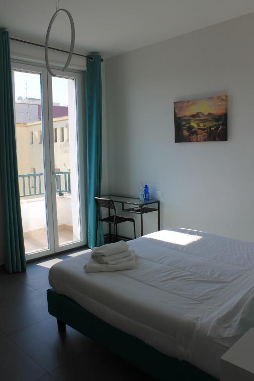 sypialnia z łóżkiem i dużym oknem w obiekcie Life Quality B&B w mieście Pescara