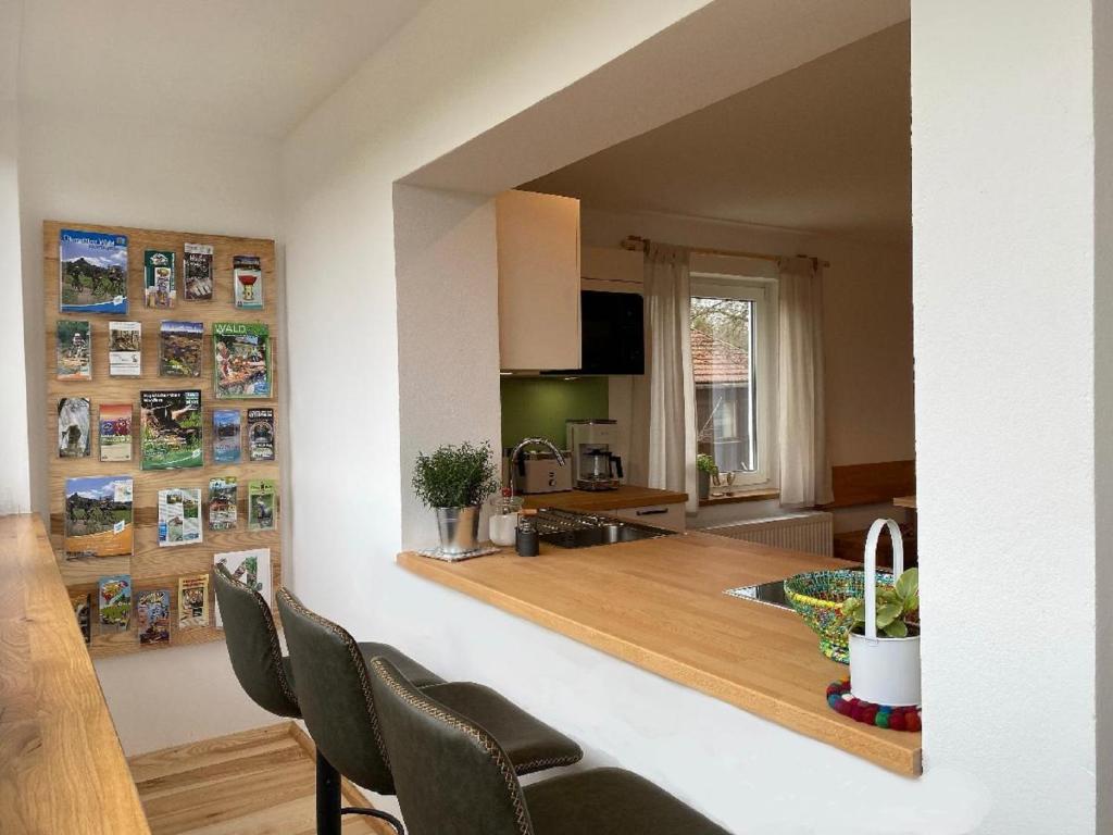 a kitchen and living room with a table and chairs at Naturspiel in Pösing