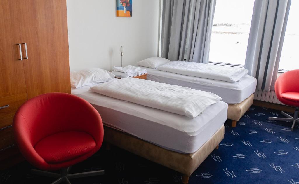 Postel nebo postele na pokoji v ubytování Hótel Dalvík