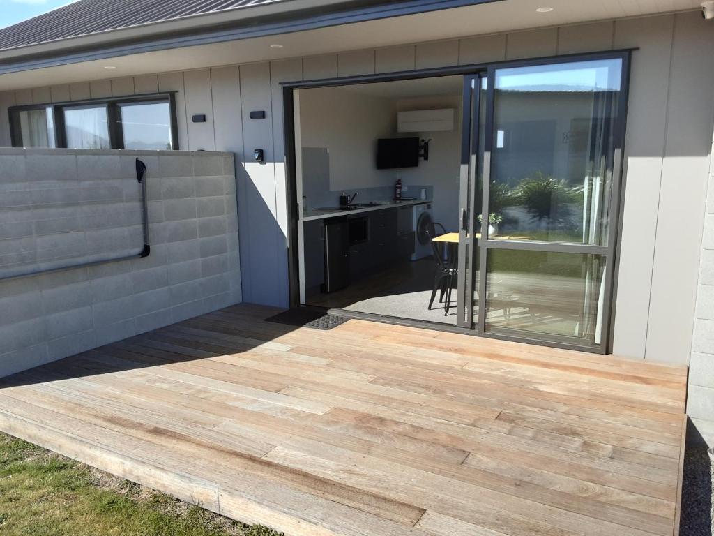 a sliding glass door on a house with a deck at Two Thumbs Unit 1 in Lake Tekapo