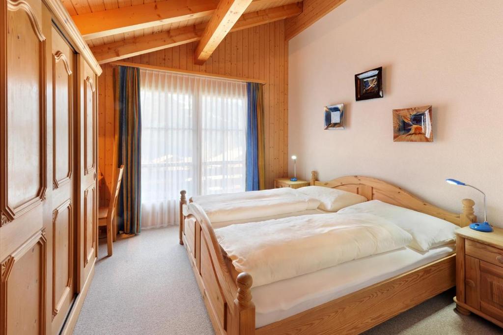Postel nebo postele na pokoji v ubytování Serviced Apartments – Kirchbühl@home