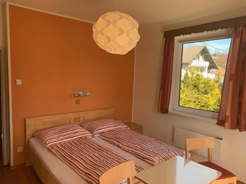 a bedroom with a bed and a window at Haus Kollin in Keutschach am See