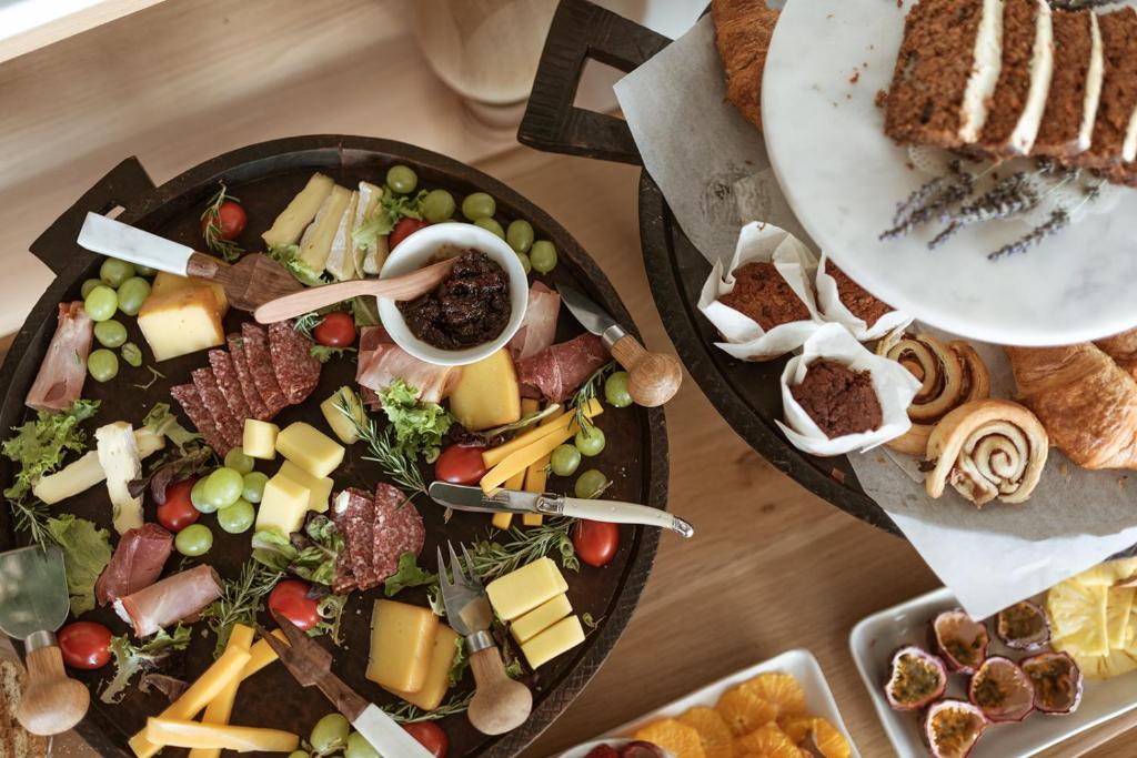 two plates of food on a table with food at Auberge Burgundy Boutique Hotel & Spa in Hermanus