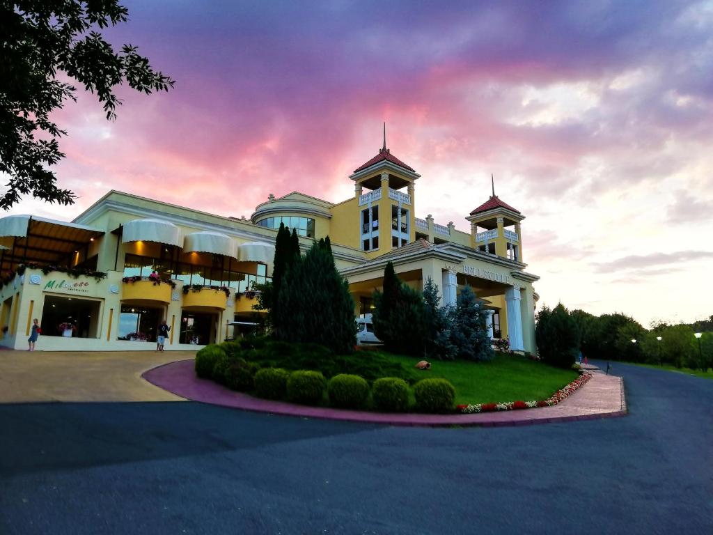 a large white building with a clock tower on it at Duni Belleville - All Inclusive in Sozopol