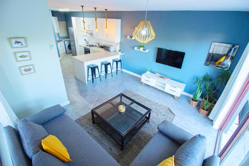 an overhead view of a living room with a couch and a table at Club Mykonos Umdloti in Umdloti
