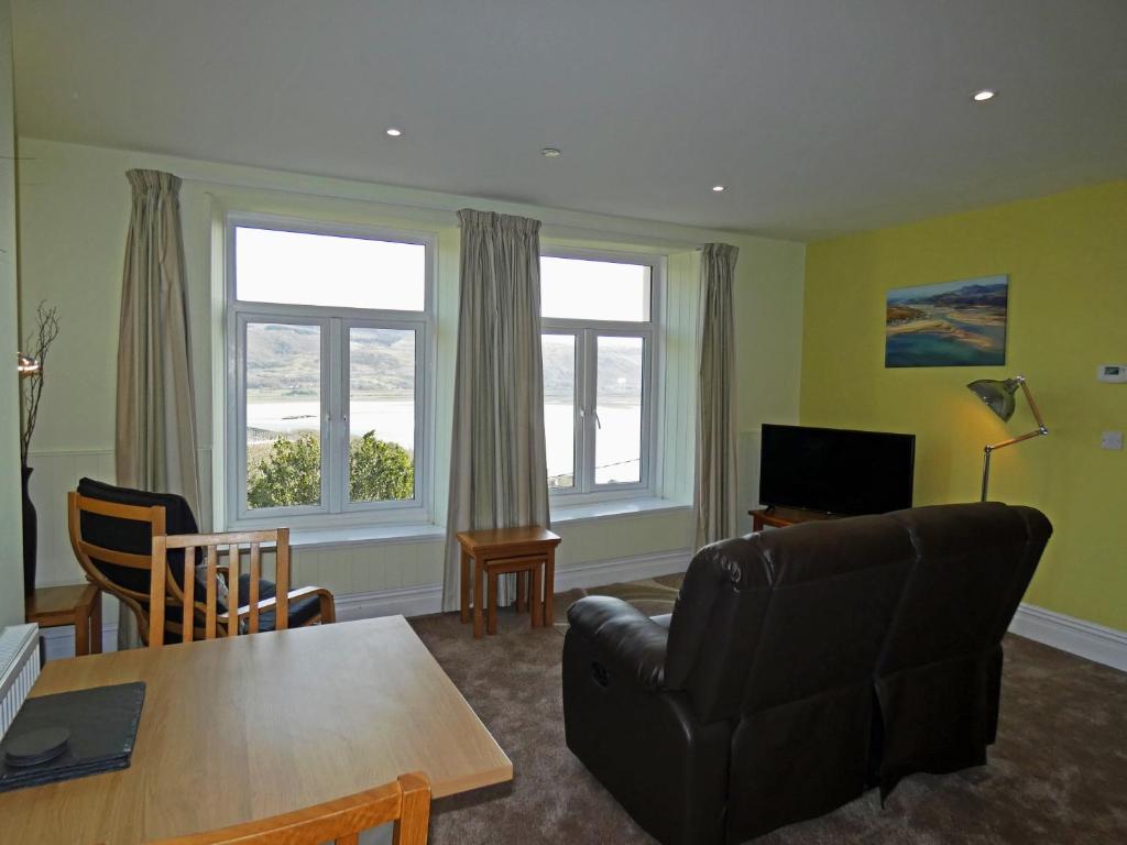 a living room with a couch and a table at Bryn Melyn Apartments in Barmouth
