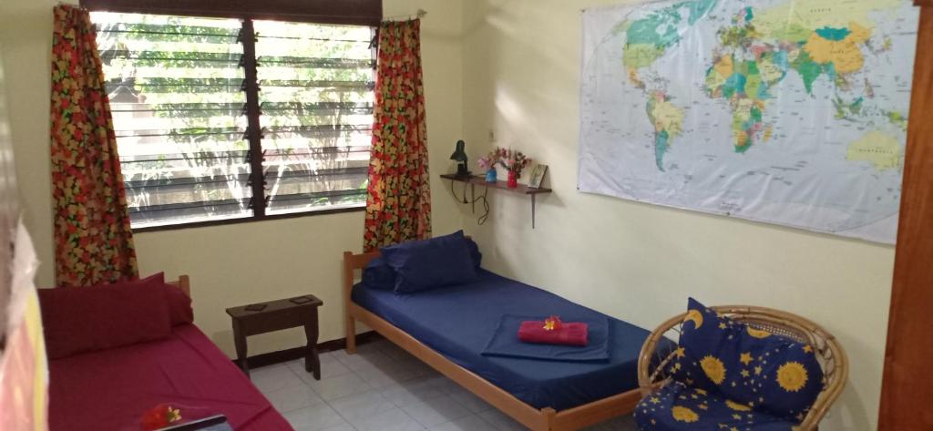 a room with a bed and a map of the world at Homestay Galpera Papua in Jayapura