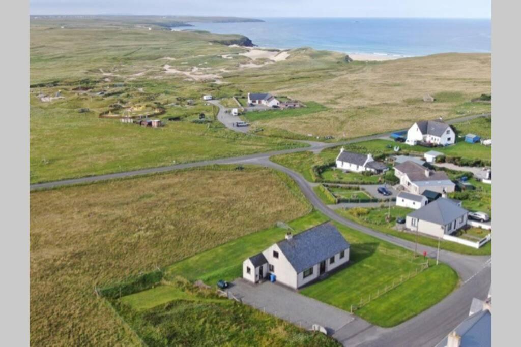 an aerial view of a village with a road and houses at Kilronan Self Catering - Eoropie, Isle of Lewis in Eoropie