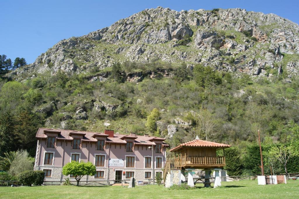 
a large stone building with a mountain range at Apartamentos Don Clemente in Las Rozas
