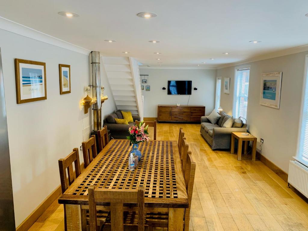 uma sala de estar com uma mesa e um sofá em Shepherds House em Swanage