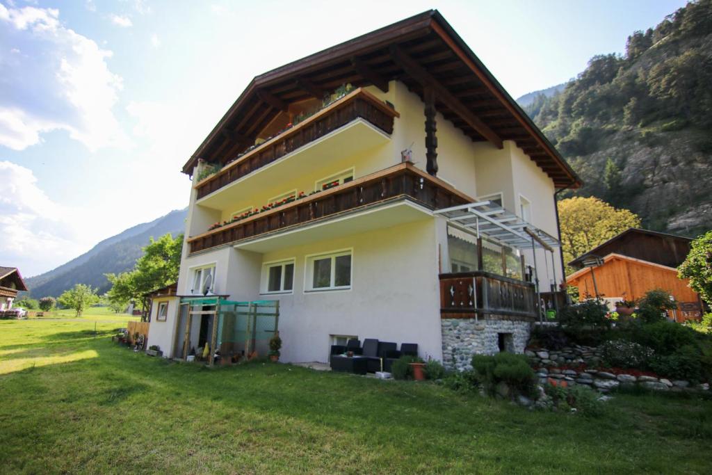 a house in a field with a mountain in the background at Ferienhaus Schmid in Serfaus