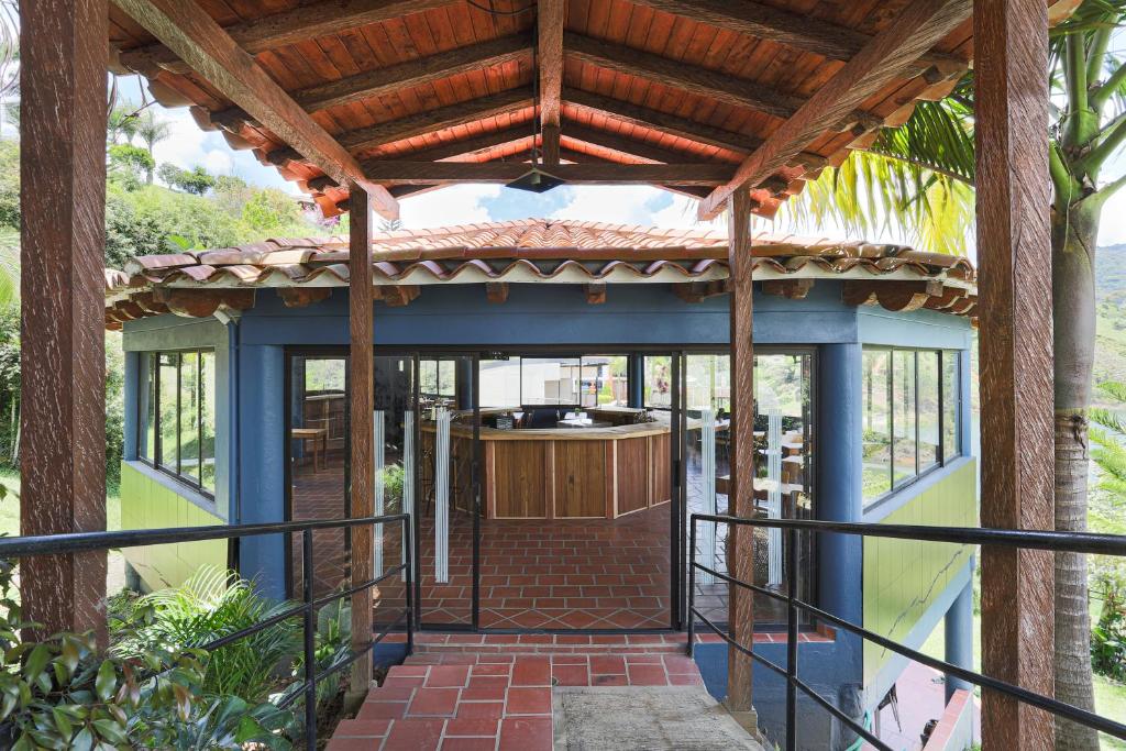an outside view of a house with a pergola at Soy Local Guatape in Guatapé