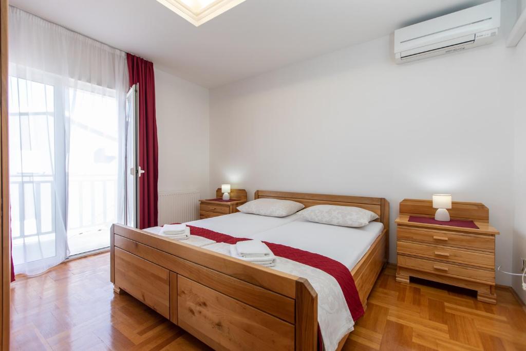 a bedroom with a bed and a large window at Hotel Buenavista Beach House Trogir in Trogir