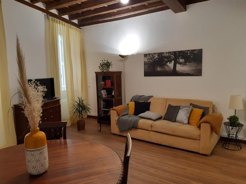 a living room with a couch and a table at Vicolo Antico Apartment in Rome