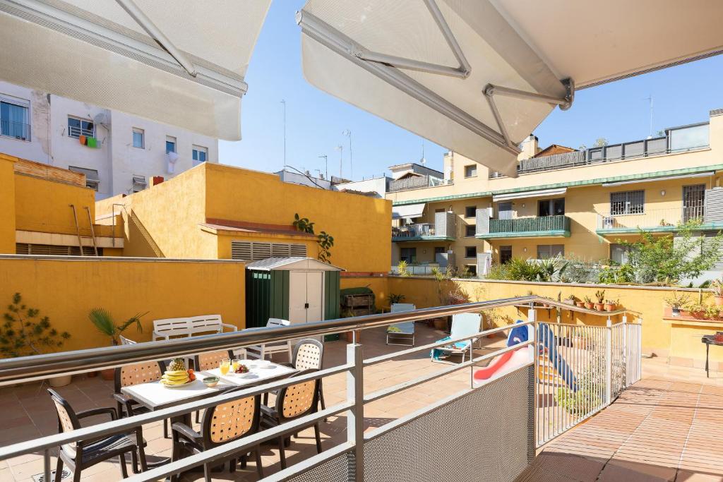 a balcony with a table and chairs on a building at Lets Holidays Terrace Barcelona in Barcelona