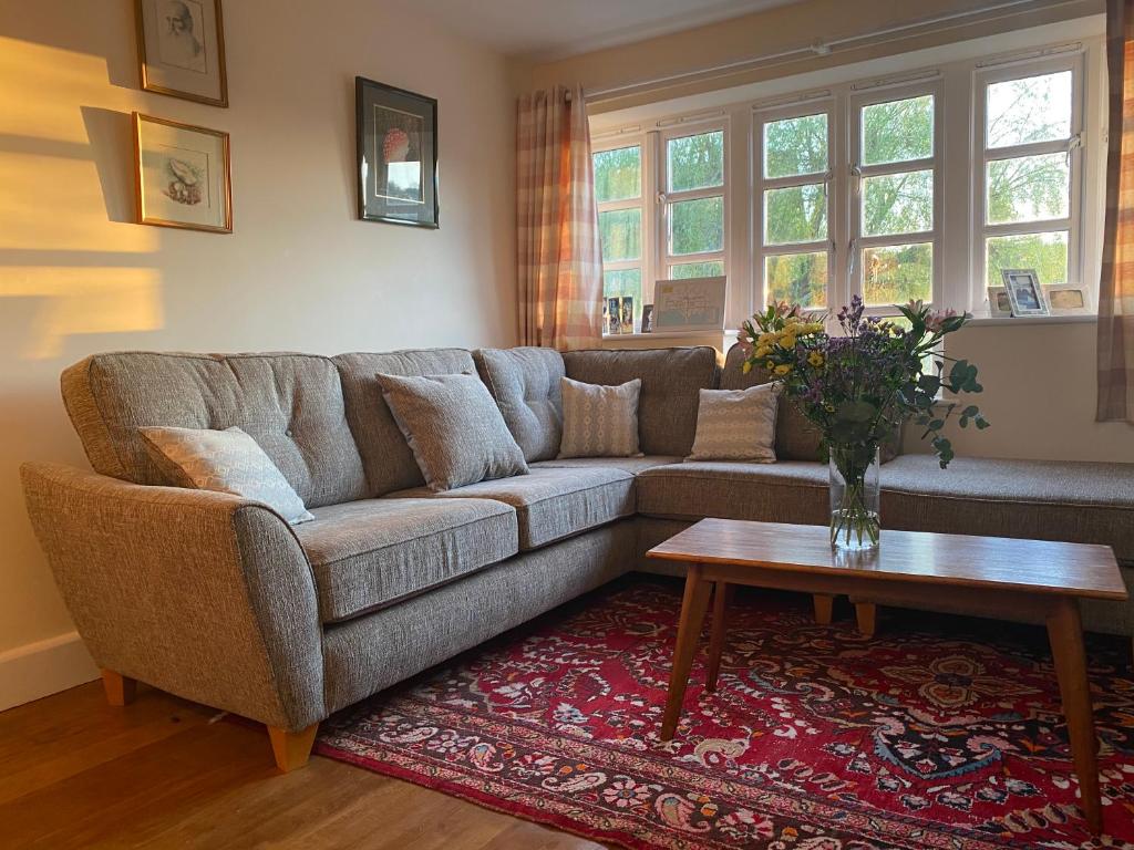 a living room with a couch and a table at Relaxing townhouse in the heart of Bridport in Bridport