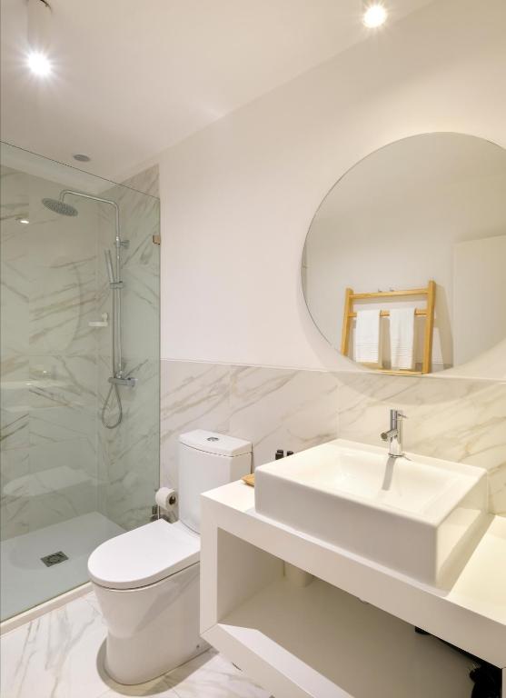 a bathroom with a sink and a toilet and a mirror at 1869 Príncipe Real House in Lisbon