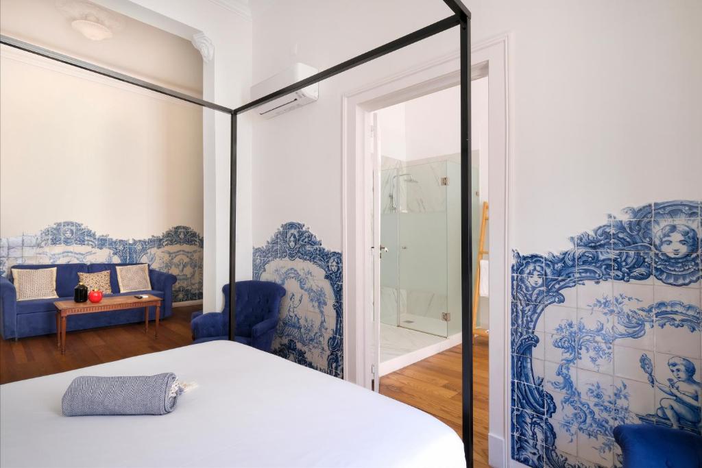 a bedroom with a bed with blue and white wallpaper at 1869 Príncipe Real House in Lisbon