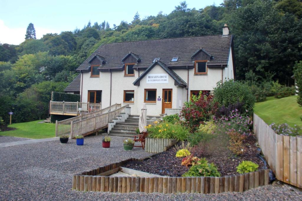 a house with a garden in front of it at Bracarina House Bed & Breakfast & Caledonian Studio in Invermoriston