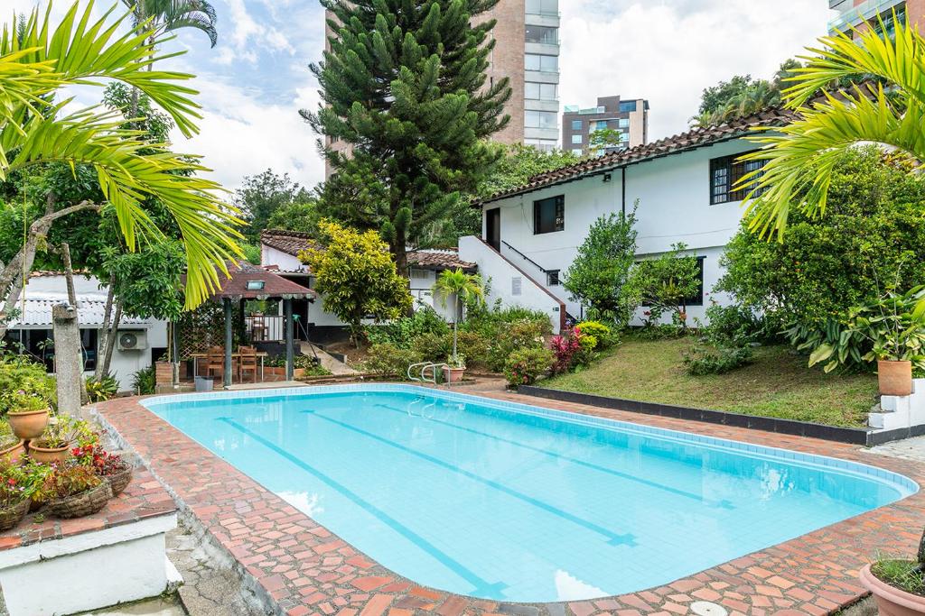 a swimming pool in front of a house at Ayenda 1257 Premium Real in Medellín