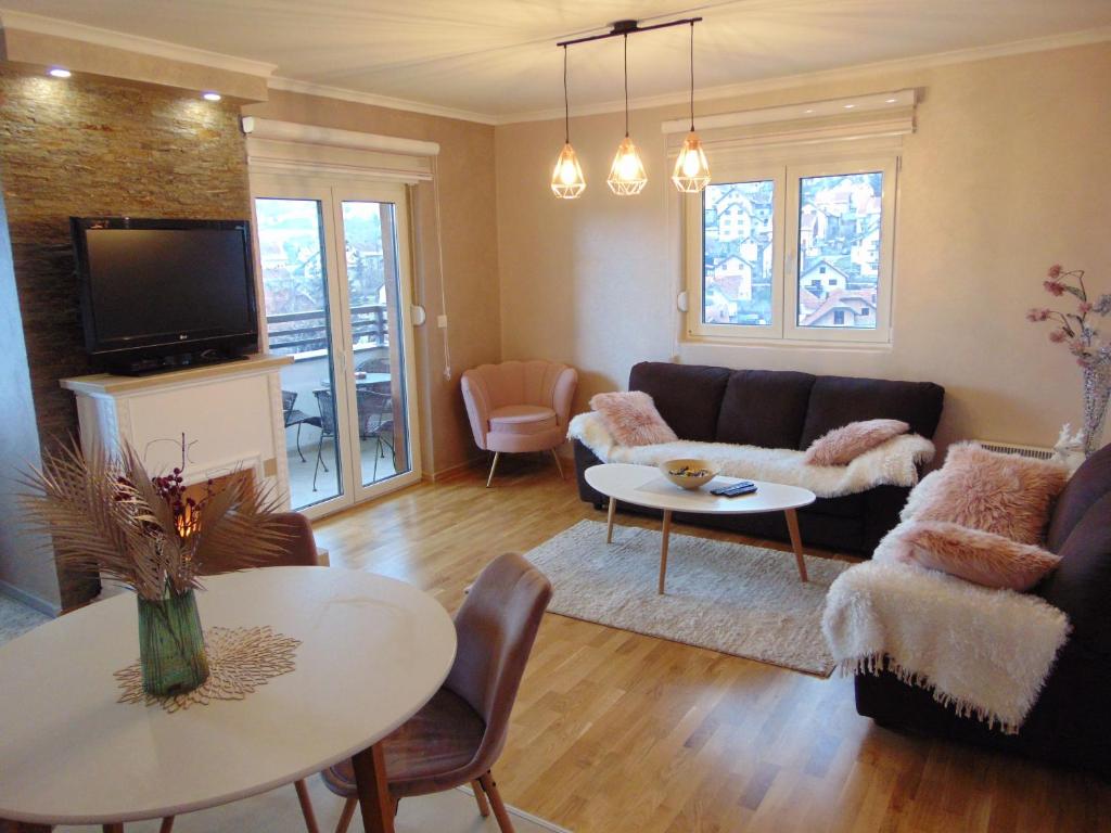 a living room with a couch and a table at Apartman Magic Zlatibor-Čajetina in Čajetina