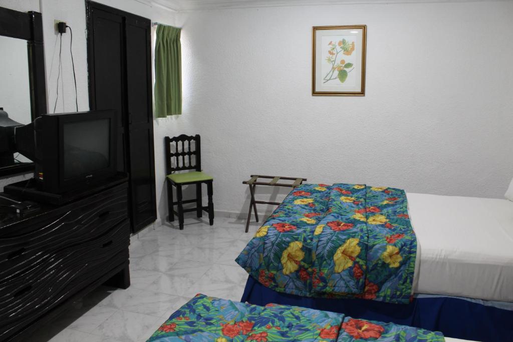 Postel nebo postele na pokoji v ubytování Hotel El Cid