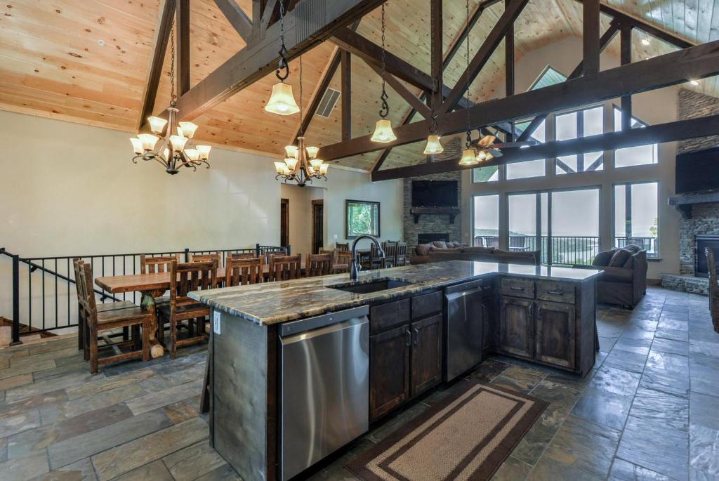 an open kitchen and dining room with wooden ceilings at Lodge 73 in Branson