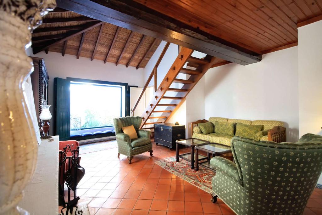 a living room with two chairs and a couch at Casa Ocre in Vila Nova de Milfontes