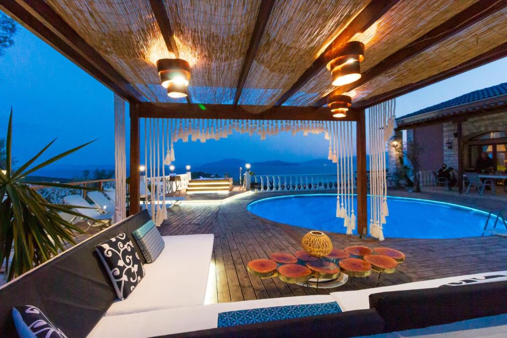 a patio with a swimming pool and a villa at Eva's Luxury Villa in Kritharia